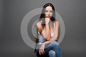 Closeup portrait of young beautiful woman with with beautiful long hair. Sitting and posing in studio. Portrait of trendy, cheerfu