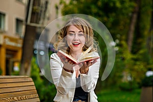 Closeup portrait of young beautiful woman with book in hands