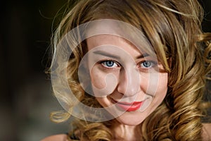 Closeup portrait of young beautiful woman looking at camera