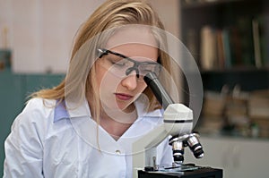 Closeup portrait young beauty blondi girl in lab