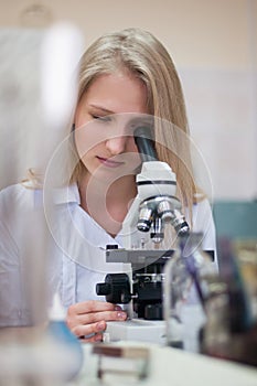 Closeup portrait young beauty blondi girl in lab