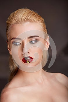 Closeup portrait of a young blonde woman bright makeup