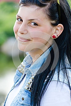 Closeup portrait of young brunette woman beautiful girl clothed in jeans shirt having fun happy smiling & looking at camera