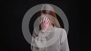 Closeup portrait of young caucasian girl getting embarrassed and regretting doing something clapping her head with a