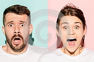 Closeup portrait of young couple, man, woman. One being excited happy smiling, other serious, concerned, unhappy on pink