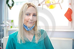 Closeup portrait of young dentist woman in dental office.