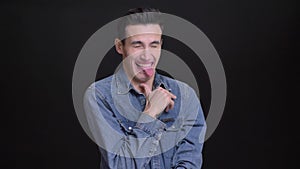 Closeup portrait of young funny caucasian man making different facial expressions and behaving silly in front of the