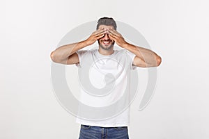 Closeup portrait of young guy, man, student, boy, worker, employee, closing eyes with hands, can`t see, hiding, isolated
