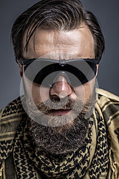 Closeup portrait of a young man with beard wearing a traditional