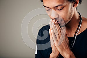 Praying african american man hoping for better. Asking God for good luck photo