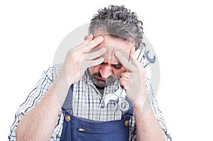 Closeup portrait of young mechanic under pressure having head ac