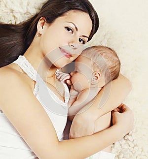 Closeup portrait young mom sleeping with baby at home