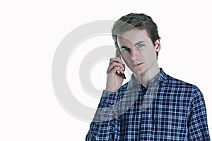 Closeup portrait of young, serious business man, corporate employee, student talking on cell phone.