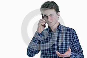 Closeup portrait of young serious business man, corporate employee, student talking on cell phone.