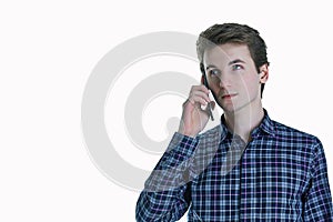 Closeup portrait of young, serious business man, corporate employee, student talking on cell phone.