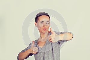 Closeup portrait young, short hair woman student being excited giving showing thumbs up hand gesture isolated light yellow