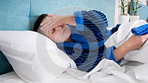 Closeup portrait of young sick wome with headache holding hand on forehead photo