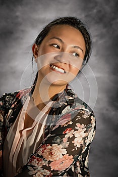 A closeup portrait of a young smiling Filipina girl.