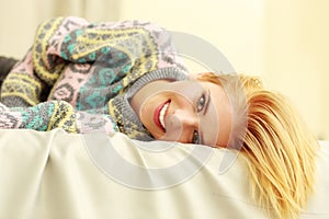 Closeup portrait of a young smiling woman lying