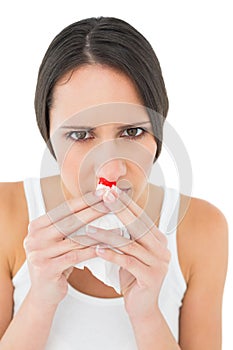 Closeup portrait of a young woman with bleeding nose