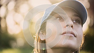 A closeup portrait of a young woman looking away from the camera