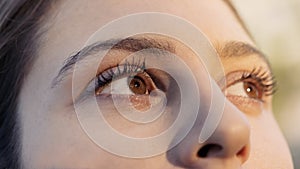 A closeup portrait of a young woman looking away from the camera