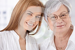 Closeup portrait of young woman and mother smiling