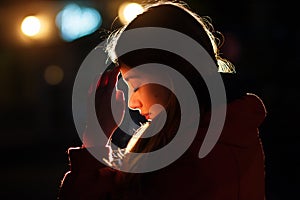 Closeup portrait of a young woman praying