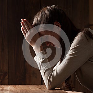 Closeup portrait of a young woman praying