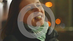 Closeup portrait of a young woman standing in the wind. The spring wind plays with the girl`s hair. Slow motion