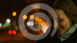 Closeup portrait of a young woman standing in the wind. The spring wind plays with the girl`s hair. Slow motion