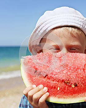 Closeup portreit boy with watermelon piece