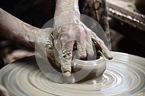 Closeup on potter man hands shaping ceramic craft