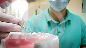 Closeup POV image of dentist using special dental instruments for inspecting teeth