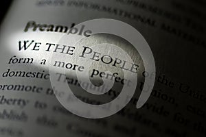 Closeup of the Preamble, We the People of the United States, printed and highlighted in textbook on white page. photo