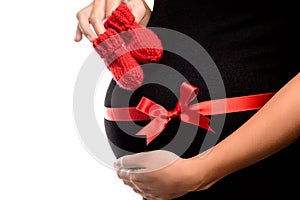 Closeup of Pregnant woman with baby's bootees