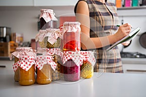 Closeup of preserved vegetables in glass jars on kitchen counter