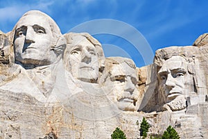 Closeup of presidential sculpture at Mount Rushmore national memorial, USA. Blue sky background.