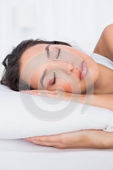 Closeup of a pretty woman sleeping with eyes closed in bed