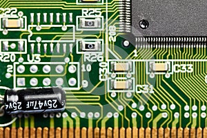 Closeup of printed circuit board with microchip, capacitor and other integrated micro elements