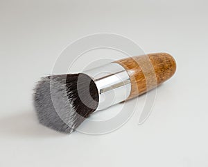 Closeup of professional makeup brush with bamboo handle on white background