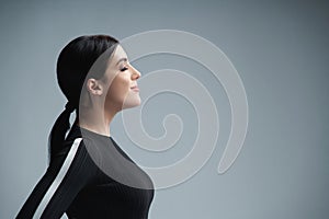 Closeup profile portrait of confident woman with closed eyes