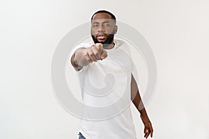 Closeup profile portrait of handsome young unhappy man, looking very angry, agitated, pointing with finger, isolated on