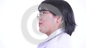 Closeup profile view of happy overweight Asian woman doctor smiling