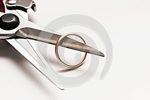 Closeup of pruner and wedding ring. Concept of wedding canceling or divorce.