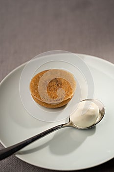 Closeup of a pudding served with a spoon of yogurt