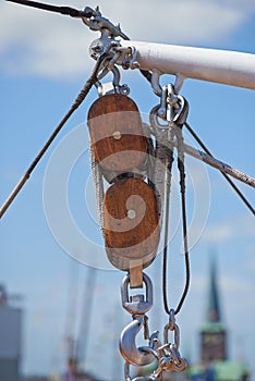 Closeup, pulley and hook with rope on ship, dock or harbor with transport and navigation for sailing. Yacht, cruise with