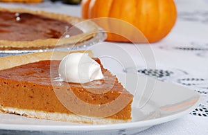 Closeup pumpkin pie slice and whip cream