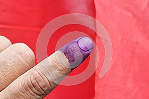 Closeup of purple indelible ink on index finger. Used in election in Malaysia to prevent fraud. photo