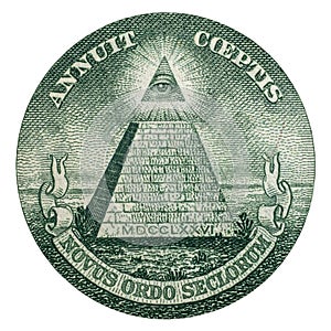 Close up of the pyramid symbol and Annuit coeptis motto and the Eye of Providence on the one dollar.